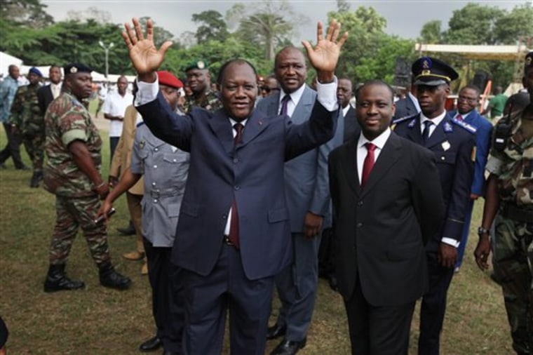 Alassane Ouattara, center, opposition leader, acknowledges supporters in Abidjan, Ivory Coast on Thursday. Ouattara is widely regarded as being the rightful winner of recent presidential elections, although incumbent leader Laurent Gbagbo refuses to relinquish power.